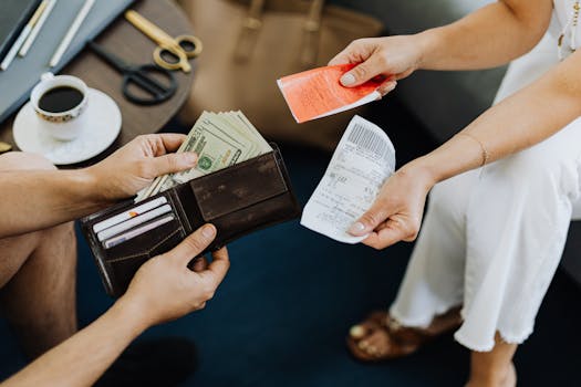 Close-up of a financial transaction involving cash and receipts over a coffee table.